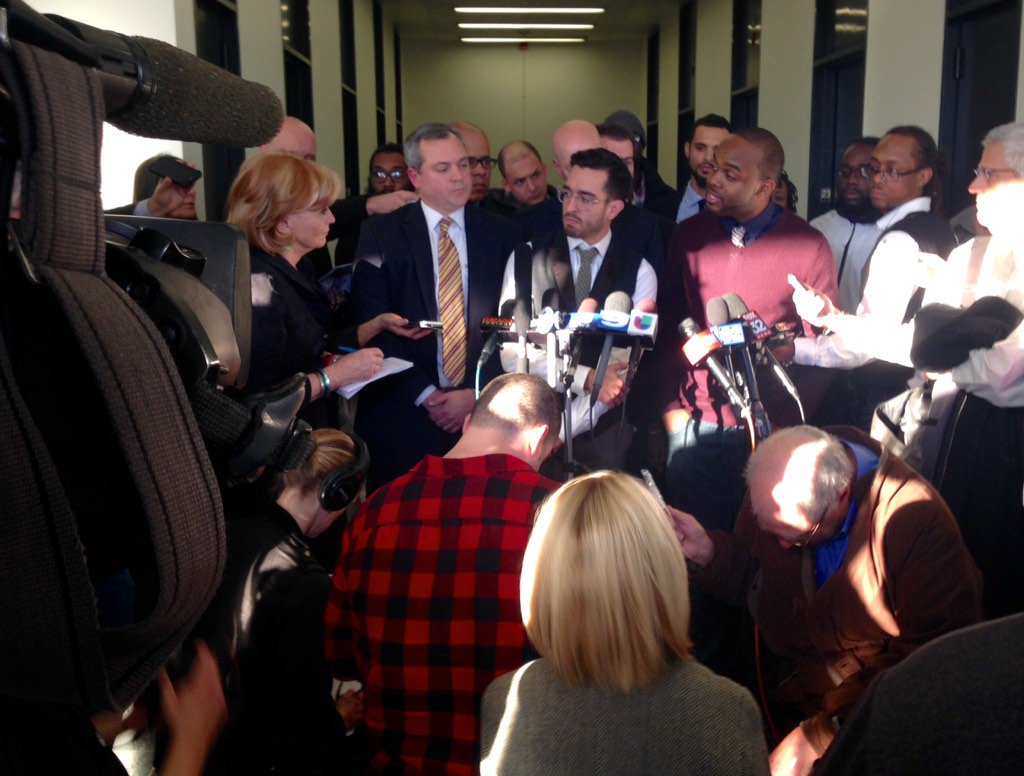 Attorney Matt Topic, Brandon Smith, and activist William Calloway answer questions from reporters at the Daley Center courthouse Nov. 19 after winning their lawsuit against the city.